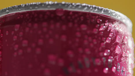 Close-Up-Of-Condensation-Droplets-On-Revolving-Takeaway-Can-Of-Cold-Beer-Or-Soft-Drink-Against-Yellow-Background-3